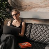 Woman sitting on a couch using a laptop