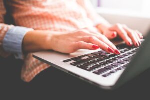 woman typing on laptop