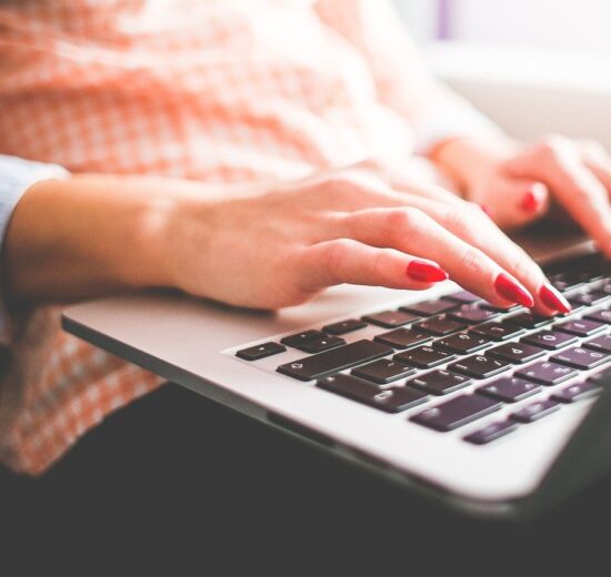 woman typing on laptop